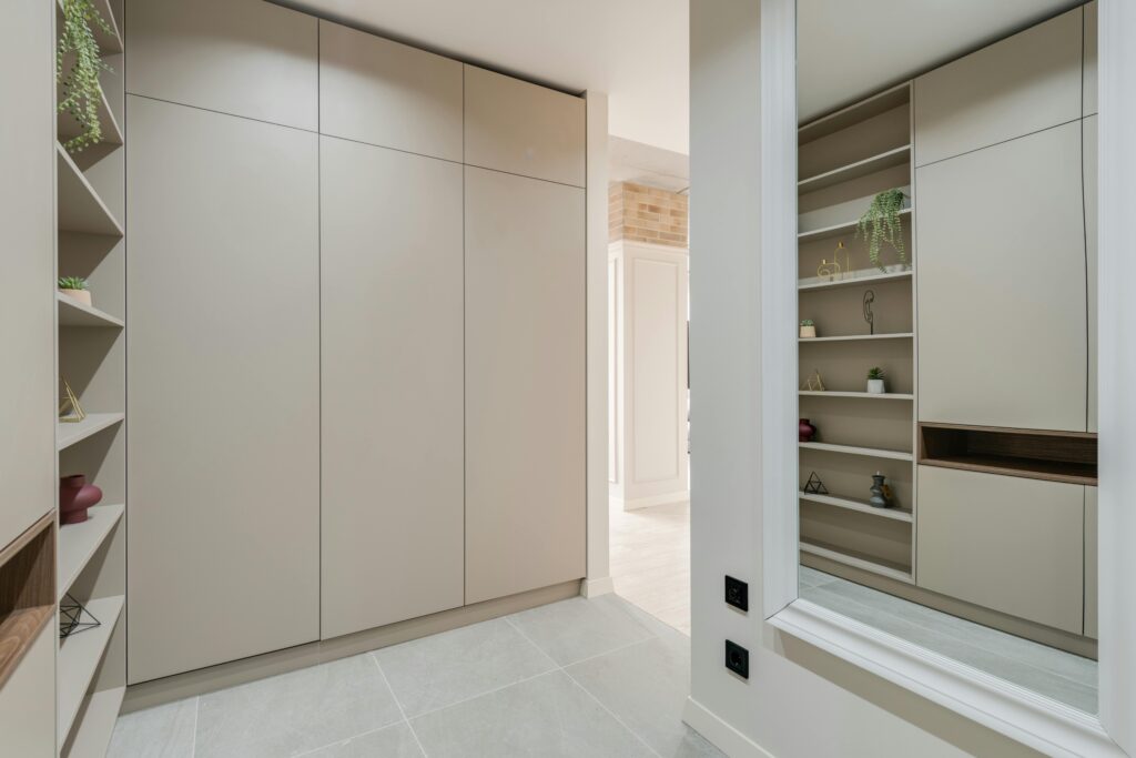 Work Portfolio Explore this sleek and modern corridor featuring minimalist design with built-in wardrobes and stylish shelves.